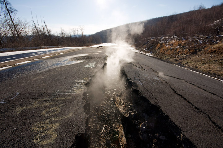 Steam rises from fissures on Centralia's old Route 61. Credit: Flickr/kaanah