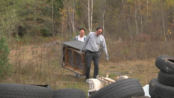 Two volunteers hauling a junk couch found in the woods around Centralia PA.