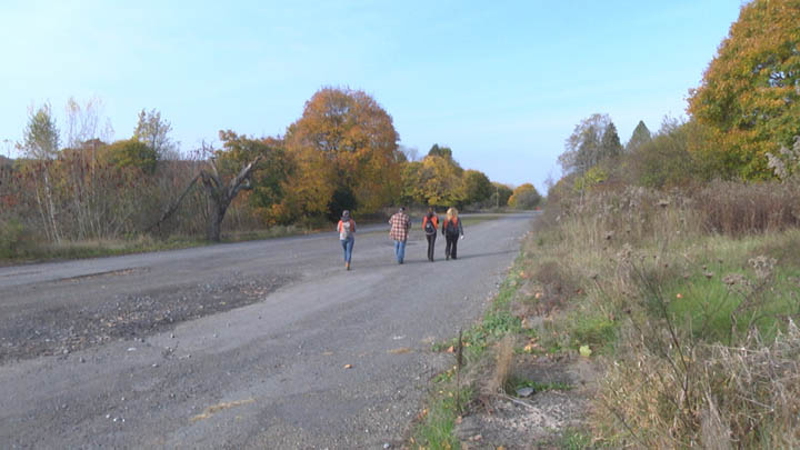 Volunteers walk down Railroad Avenue in Centralia after cleaning up trash from the wooded areas nearby.